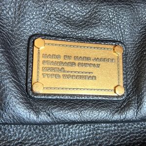 A black leather cross body shoulder bag by Mark Jacobs